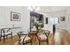 Open dining room with hardwood floors that seamlessly connects to the kitchen with a stainless-steel refrigerator at 1672 Dekalb Ne Ave # 2, Atlanta, GA 30307