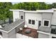 Contemporary home features a rooftop patio, perfect for outdoor living and entertaining with seating and a fire pit at 1672 Dekalb Ne Ave # 2, Atlanta, GA 30307