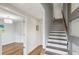 Hallway featuring hardwood floors, a staircase, and an open doorway leading to the living area at 1672 Dekalb Ne Ave # 2, Atlanta, GA 30307