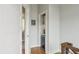 Hallway with hardwood floors, offering a glimpse into a cozy nook with storage and a small refrigerator at 1672 Dekalb Ne Ave # 2, Atlanta, GA 30307