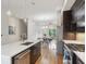 Bright and modern kitchen featuring a large island, stainless steel appliances, and contemporary lighting fixtures at 1672 Dekalb Ne Ave # 2, Atlanta, GA 30307