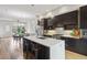 Modern kitchen with stainless steel appliances, an island with seating, and hardwood floors at 1672 Dekalb Ne Ave # 2, Atlanta, GA 30307