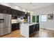 Modern kitchen features stainless steel appliances, a central island, and hardwood floors at 1672 Dekalb Ne Ave # 2, Atlanta, GA 30307