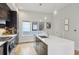 Contemporary kitchen featuring an island with seating, modern lighting, and stainless-steel appliances at 1672 Dekalb Ne Ave # 2, Atlanta, GA 30307