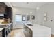 Modern kitchen with stainless steel appliances, island with sink, and hardwood floors at 1672 Dekalb Ne Ave # 2, Atlanta, GA 30307