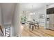 Spacious living room with hardwood floors, modern furnishings, a dining area, and a stainless steel refrigerator at 1672 Dekalb Ne Ave # 2, Atlanta, GA 30307