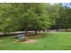 Scenic view of a lush park featuring a bench under mature trees and green lawn at 1672 Dekalb Ne Ave # 2, Atlanta, GA 30307