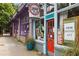 Charming gallery storefront with a bright red door, custom framing signage, and eye-catching window displays at 1672 Dekalb Ne Ave # 2, Atlanta, GA 30307