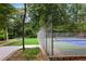 Outdoor tennis court surrounded by lush greenery, providing a private recreational space at 1672 Dekalb Ne Ave # 2, Atlanta, GA 30307