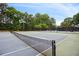 Well-maintained tennis court with net, surrounded by trees, perfect for recreational play at 1672 Dekalb Ne Ave # 2, Atlanta, GA 30307