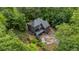 Aerial view of home surrounded by mature trees with a deck and basketball court at 270 Shady Marsh Trl, Roswell, GA 30075