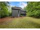 Backyard of home with grass and landscaping and views of surrounding trees at 270 Shady Marsh Trl, Roswell, GA 30075