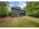 Backyard view with wooded backdrop and mature lawn at 270 Shady Marsh Trl, Roswell, GA 30075
