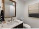 Elegant powder room with a modern vanity, designer mirror, and stylish artwork, creating a luxurious space at 270 Shady Marsh Trl, Roswell, GA 30075