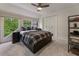 Cozy bedroom with a plaid comforter, carpet floors, large window and a ceiling fan with a light at 270 Shady Marsh Trl, Roswell, GA 30075