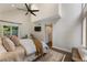 Comfortable primary bedroom featuring high ceilings, a ceiling fan, and a sliding barn door at 270 Shady Marsh Trl, Roswell, GA 30075