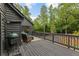 Elevated deck with outdoor seating and a grill, providing a perfect spot to enjoy the scenic wooded surroundings at 270 Shady Marsh Trl, Roswell, GA 30075