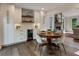The dining area features a wine fridge, built-in cabinets, open shelving, and a stone fireplace creating an elegant atmosphere at 270 Shady Marsh Trl, Roswell, GA 30075