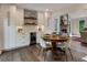 Dining area with modern white chairs, hardwood floors, and open access to the living area at 270 Shady Marsh Trl, Roswell, GA 30075