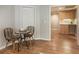 A cozy dining area features a small table with two chairs and seamless wood flooring for casual dining at 270 Shady Marsh Trl, Roswell, GA 30075