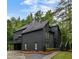 Contemporary home with a dark exterior, lush landscaping, and a private driveway at 270 Shady Marsh Trl, Roswell, GA 30075