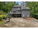 Dark gray exterior home with a spacious deck, two-car garage, and a basketball hoop on the driveway at 270 Shady Marsh Trl, Roswell, GA 30075
