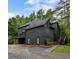 Modern home with a dark exterior, mature trees, and a well-maintained yard at 270 Shady Marsh Trl, Roswell, GA 30075