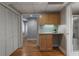Functional hallway featuring a built-in desk, closet, hardwood floors, and neutral walls at 270 Shady Marsh Trl, Roswell, GA 30075