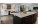 This open concept kitchen features an island with seating, stainless appliances, and a seamless flow into the dining area at 270 Shady Marsh Trl, Roswell, GA 30075