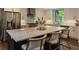 A bright kitchen is equipped with a large island with seating, stainless steel appliances, and ample counter space at 270 Shady Marsh Trl, Roswell, GA 30075
