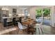 Spacious kitchen with stainless steel appliances, white cabinets, a large island, and a dining area with deck access at 270 Shady Marsh Trl, Roswell, GA 30075