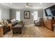 Inviting living room with a cozy couch, ottoman, and a large area rug, creating a comfortable atmosphere at 270 Shady Marsh Trl, Roswell, GA 30075