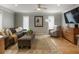 Cozy living room featuring a comfortable sofa, stylish decor, hardwood floors and a ceiling fan at 270 Shady Marsh Trl, Roswell, GA 30075