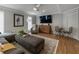 Spacious living room featuring a comfortable couch, a stylish rug, and a large screen television at 270 Shady Marsh Trl, Roswell, GA 30075