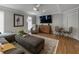 A stylish living room features wood flooring, a cozy seating arrangement, and a large television at 270 Shady Marsh Trl, Roswell, GA 30075
