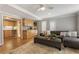 Open-concept living room with hardwood floors, ample seating, kitchenette, and plenty of natural light at 270 Shady Marsh Trl, Roswell, GA 30075
