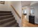 Carpeted staircase leading to the downstairs living area with hardwood floors at 270 Shady Marsh Trl, Roswell, GA 30075