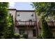 Backyard features a wooden deck with steps leading down to a patio and greenery at 3220 Creole Ln, Avondale Estates, GA 30002