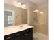 Modern bathroom featuring a glass-enclosed shower and a dark vanity with a white countertop at 3220 Creole Ln, Avondale Estates, GA 30002