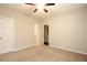 Bedroom with neutral walls, carpet, ceiling fan, and connecting doors at 3220 Creole Ln, Avondale Estates, GA 30002