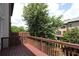 View from a wooden deck featuring a wood fence, trees, and neighboring townhomes at 3220 Creole Ln, Avondale Estates, GA 30002