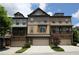 Charming townhomes featuring a modern exterior with multi-car garages and brick accents at 3220 Creole Ln, Avondale Estates, GA 30002