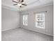 Bright main bedroom features a tray ceiling and ample natural light from two large windows at 3220 Creole Ln, Avondale Estates, GA 30002