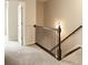Carpeted staircase with dark wood railing leads to the upper level at 3220 Creole Ln, Avondale Estates, GA 30002