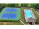Overhead shot of community tennis courts and pool with lounge chairs at 3668 Burel Mill Dr, Buford, GA 30519