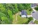 Aerial view of a home with a spacious backyard, mature trees, and a private setting at 3668 Burel Mill Dr, Buford, GA 30519