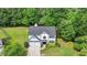 Aerial view of home showcasing mature trees, well maintained lawn and neutral-colored home at 3668 Burel Mill Dr, Buford, GA 30519