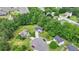 Aerial view of a charming two-story home on a cul-de-sac with mature trees and green spaces at 3668 Burel Mill Dr, Buford, GA 30519
