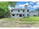 Back view of house with a large green backyard and patio, perfect for enjoying the outdoors at 3668 Burel Mill Dr, Buford, GA 30519