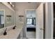 Bathroom vanity area featuring double sinks, and an open doorway leading to the bedroom at 3668 Burel Mill Dr, Buford, GA 30519